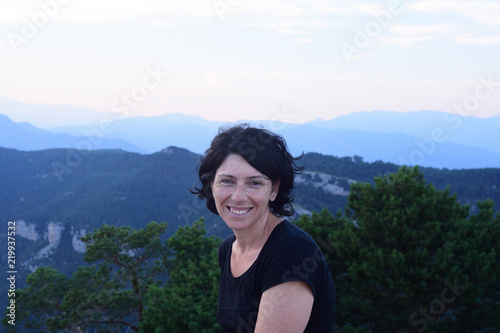 portrait of a female hiker with mountain in background