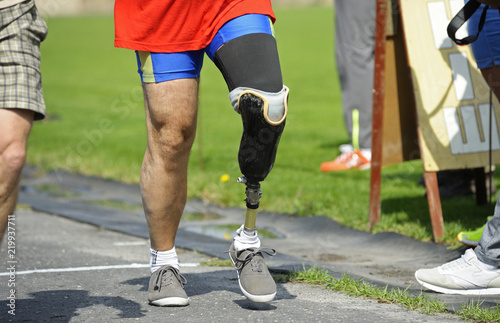 Disabled athlete with an artificial leg walking on a stadium. Trials among disabled Ukrainian soldiers to the 43 rd US Marine Corps marathon. July 20, 2018. Kiev, Ukraine
