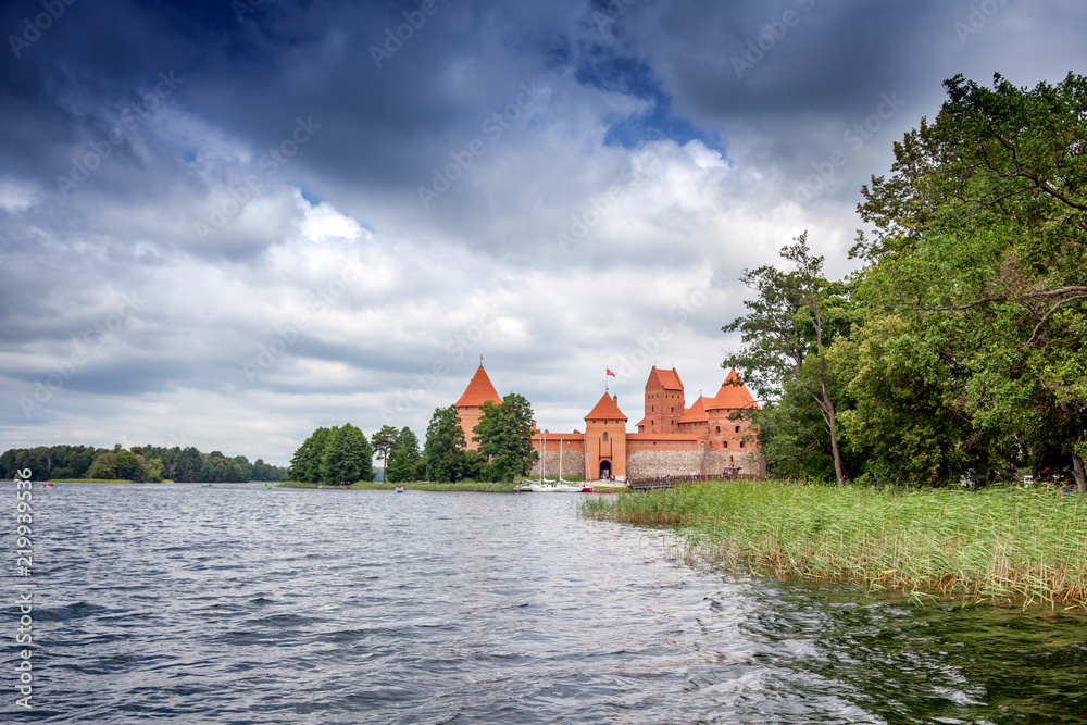 Medieval gothic Trakai Island Castle with stone walls and towers with red tiled roofs in Lake Galve, Lithuania