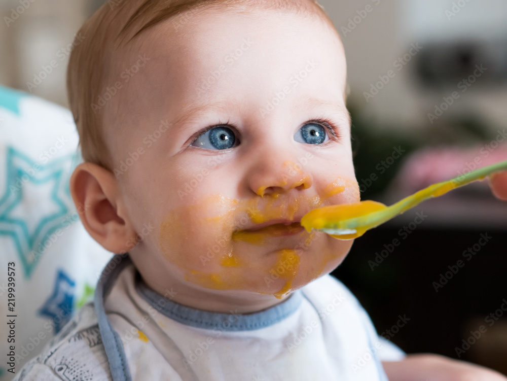 Mother feeding cute baby boy with blue eyes Mother feeding cute baby boy with blue eyes