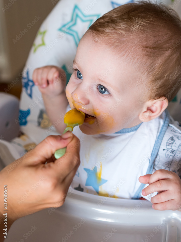 Mom feeding cute redhead boy wiht blue eyes top view Mom feeding cute redhead boy wiht blue eyes top view