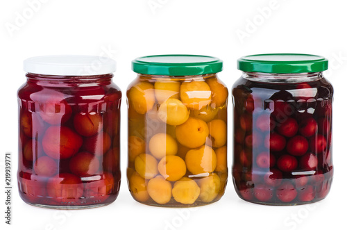 Glass jars with preserved apricots, cherries and plums