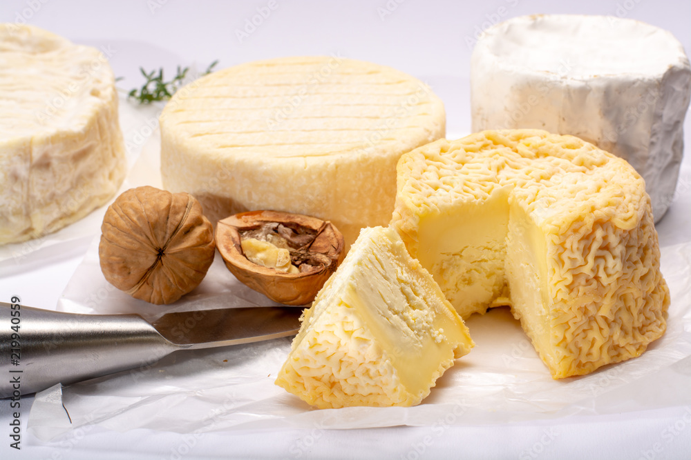 French AOC soft cow cheeses, crumbly Langres with washed rind structure, sharp Pie Angloys, camembert with strong taste and brie served as dessert after dinner