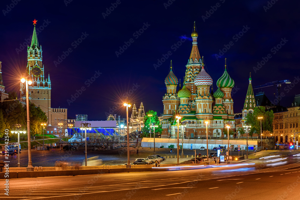 Obraz premium Spasskaya Tower, Moscow Kremlin and Saint Basil s Cathedral in Moscow, Russia. Architecture and landmarks of Moscow. Postcard of Moscow