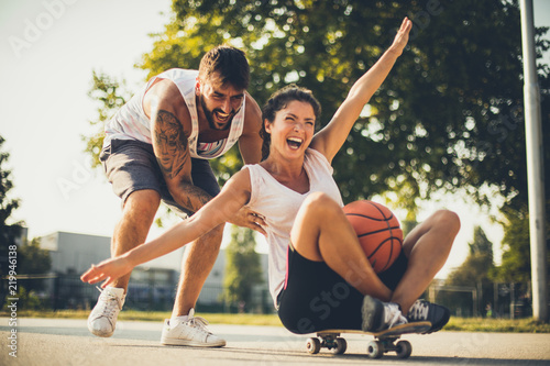 Couple have fun on skateboard.