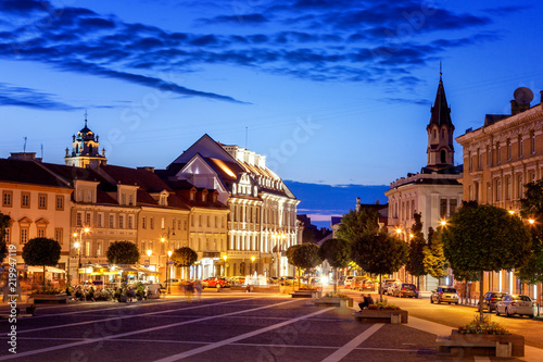 Vilnius, the capital of Lithuania at sunset, a street and square with bright night lights in the historic center of the city at night, a popular destination for travel in Europe