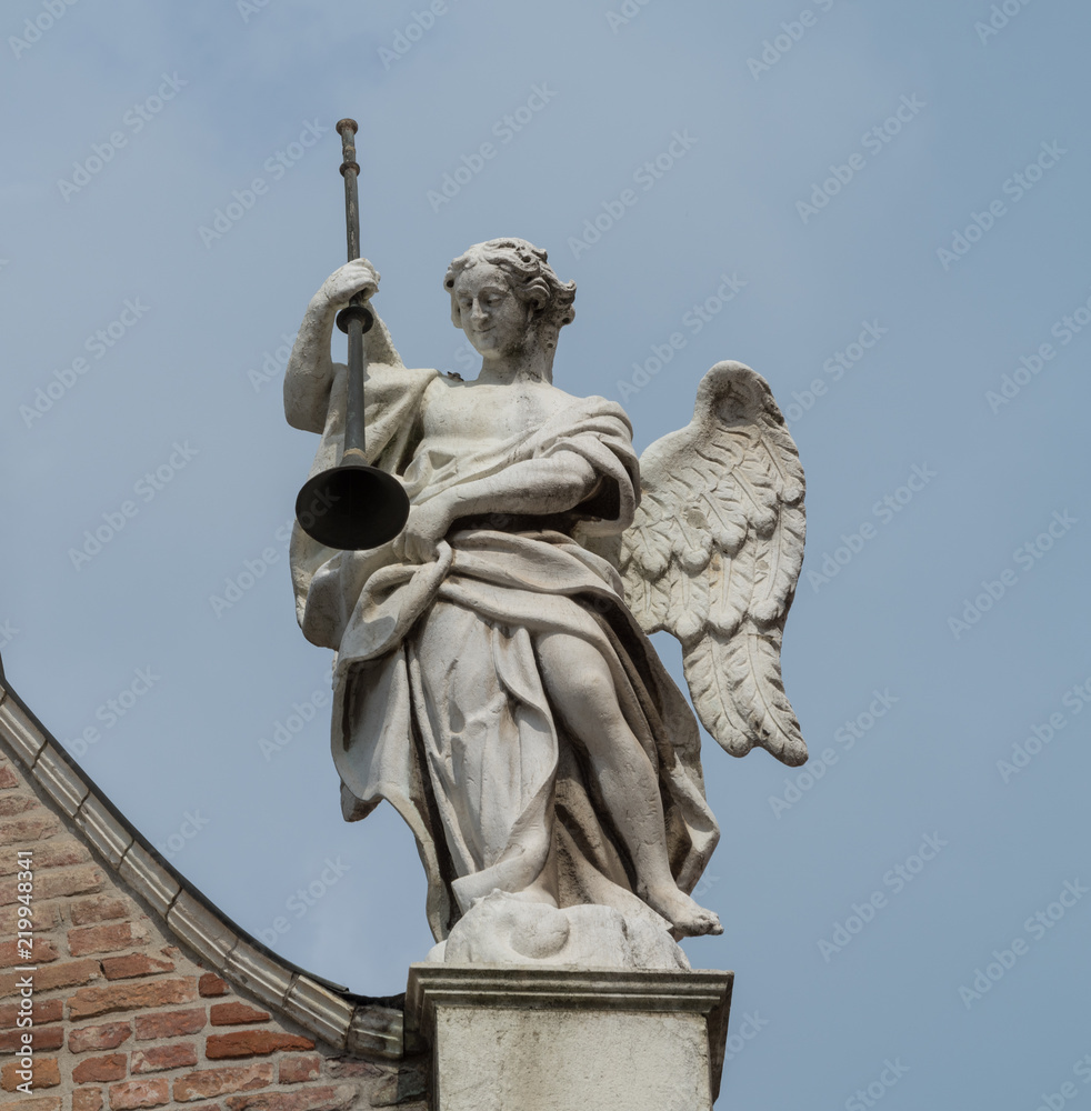 Angel statue on the facade of Cremona Cathedral, Italy