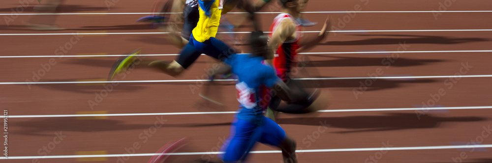 Naklejka premium running men sprinters runners in 100 meters blurred motion