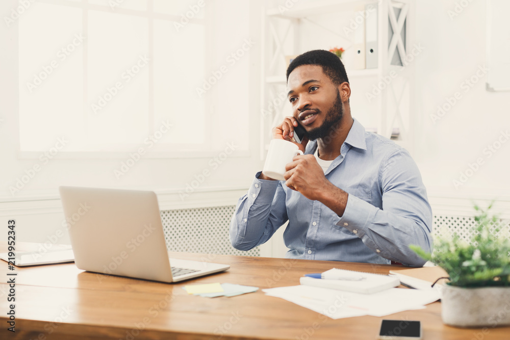 Young black businessman talking on mobile phone Young black businessman talking on mobile phone