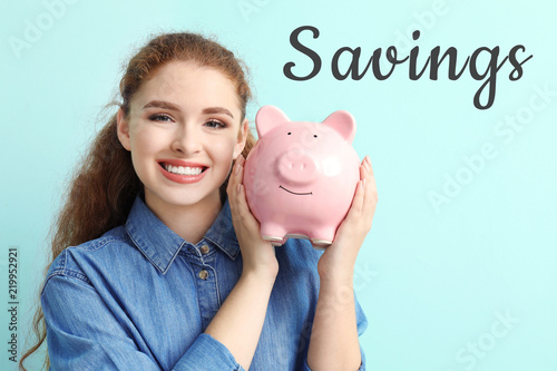 Young woman holding piggy b...