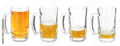 Foto Mugs with different amount of beer on white background
