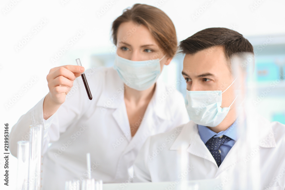Female and male scientists working in laboratory Female and male scientists working in laboratory