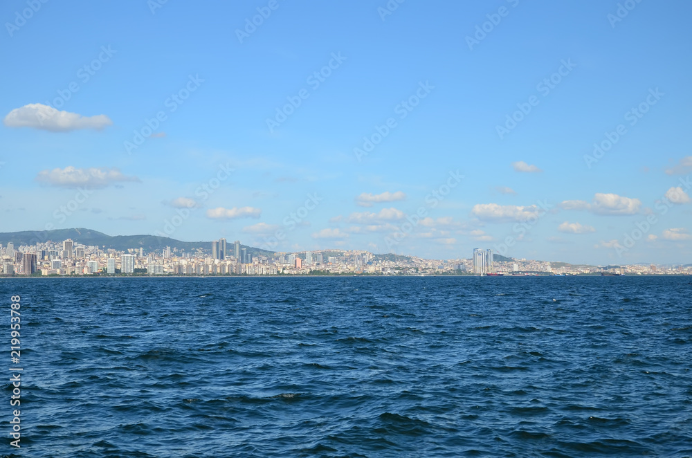View to Istanbul from Prince's Islands (Büyükada). Sea cityscape with modern skyscrapers of Istanbul. Beautiful blue sky with white clouds