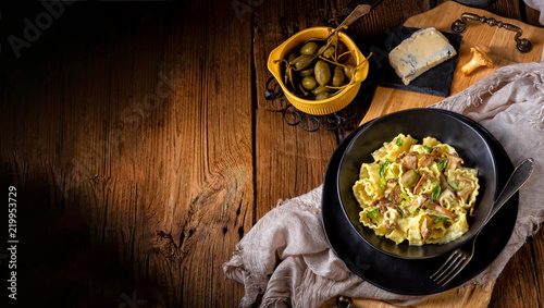 Reginette noodles in cream sauce with fresh chanterelles and capers photo