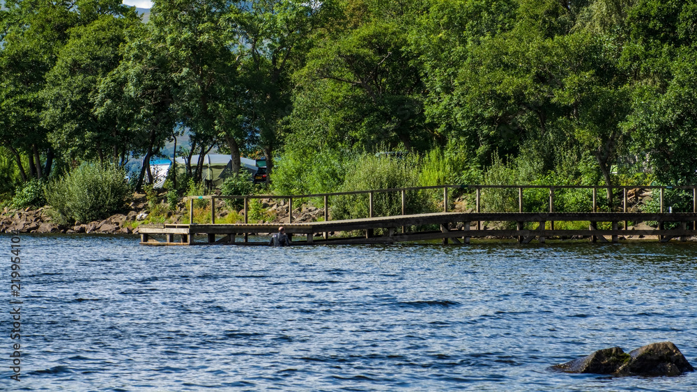 Little wooden pier on a lake.