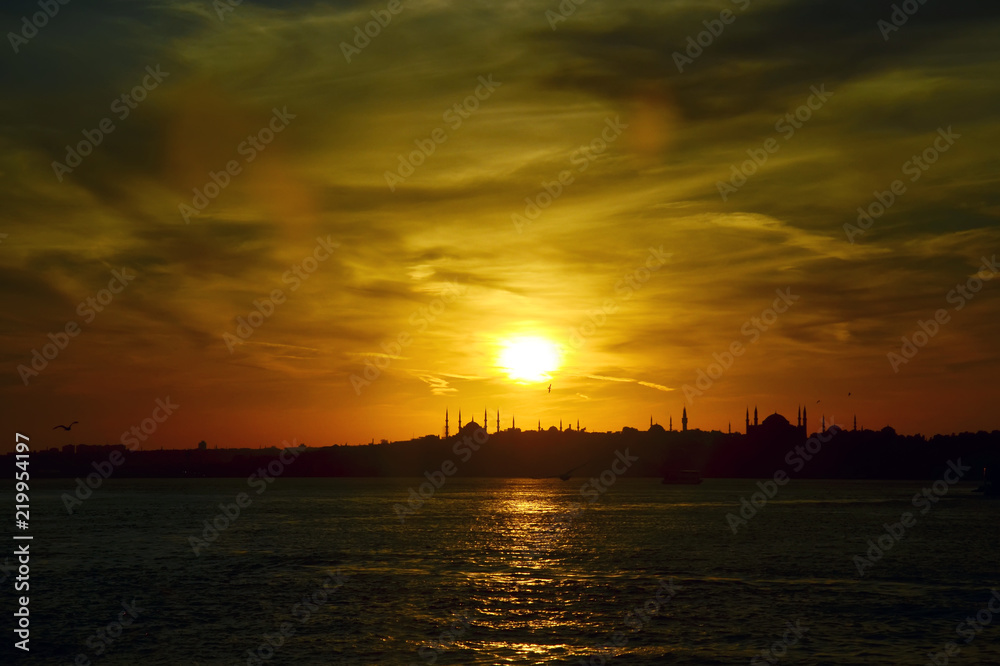 Sunset.Silhouettes  of Sultan Ahmed Mosque (Blue Mosque) and  Hagia Sophia (Ayasofya) Mosque. View from sea of Marmara.  Beautiful colorful sky. Istanbul, Turkey.