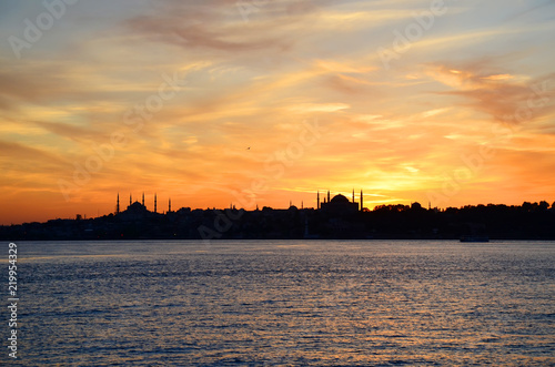Sunset.Silhouettes of Sultan Ahmed Mosque (Blue Mosque) and Hagia Sophia (Ayasofya) Mosque. View from sea of Marmara. Beautiful colorful sky. Istanbul, Turkey.