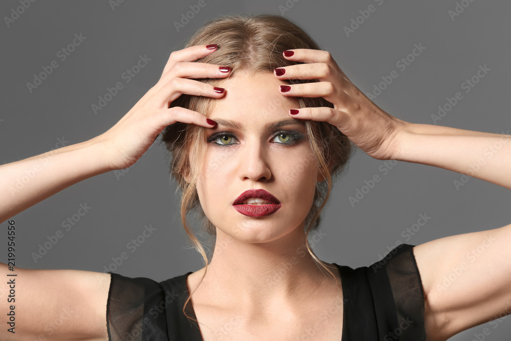 Fototapeta premium Fashionable young woman with beautiful manicure on grey background