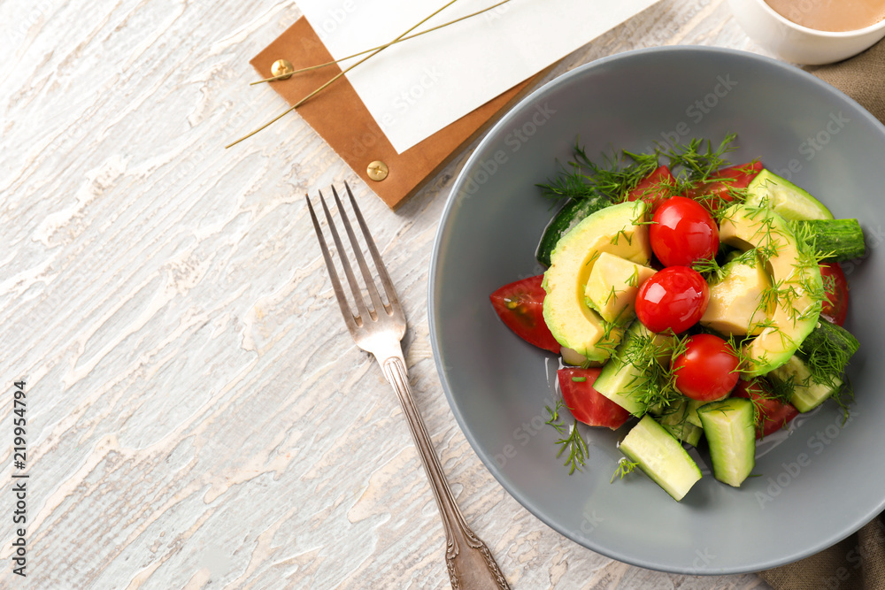 Plate with tasty vegetable salad on table Plate with tasty vegetable salad on table
