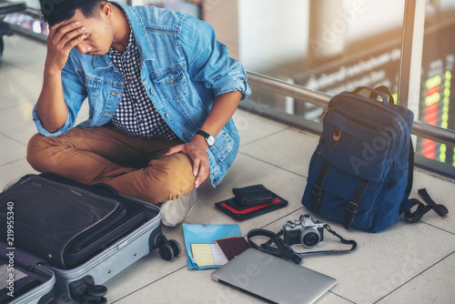 An Asian male traveler is experiencing the problem of need and lost value at the airport.