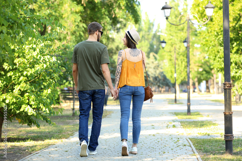 Happy lovely couple walking in park on sunny day Happy lovely couple walking in park on sunny day