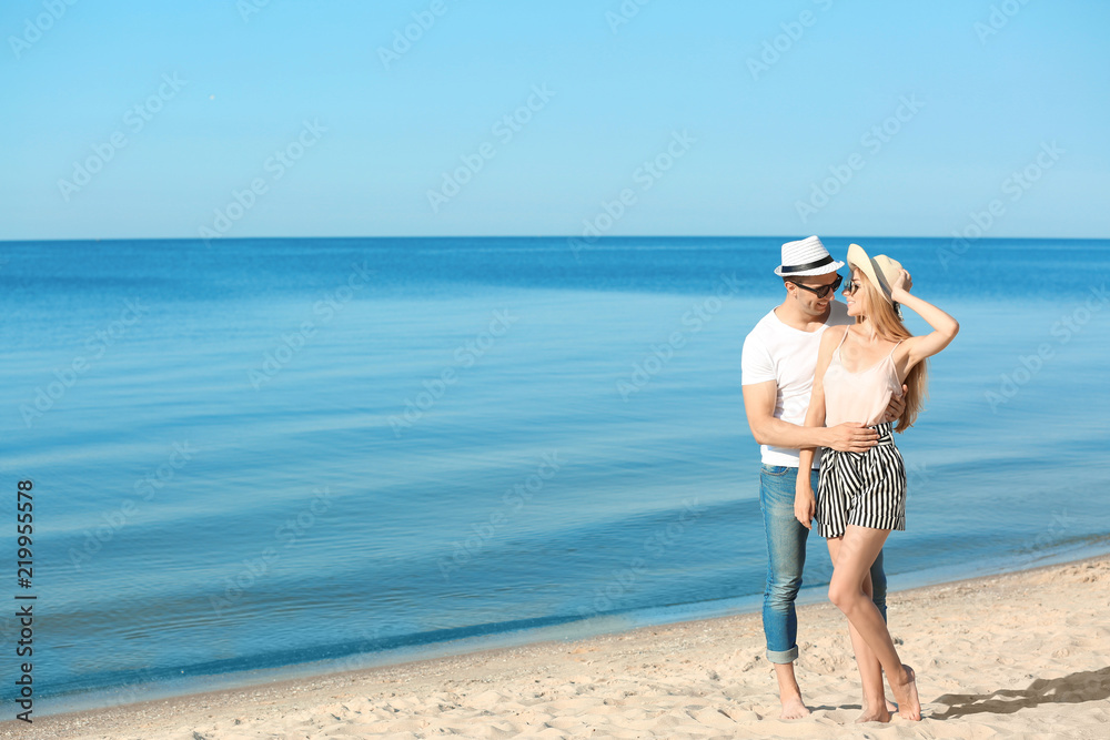 Happy young couple near sea on summer day Happy young couple near sea on summer day