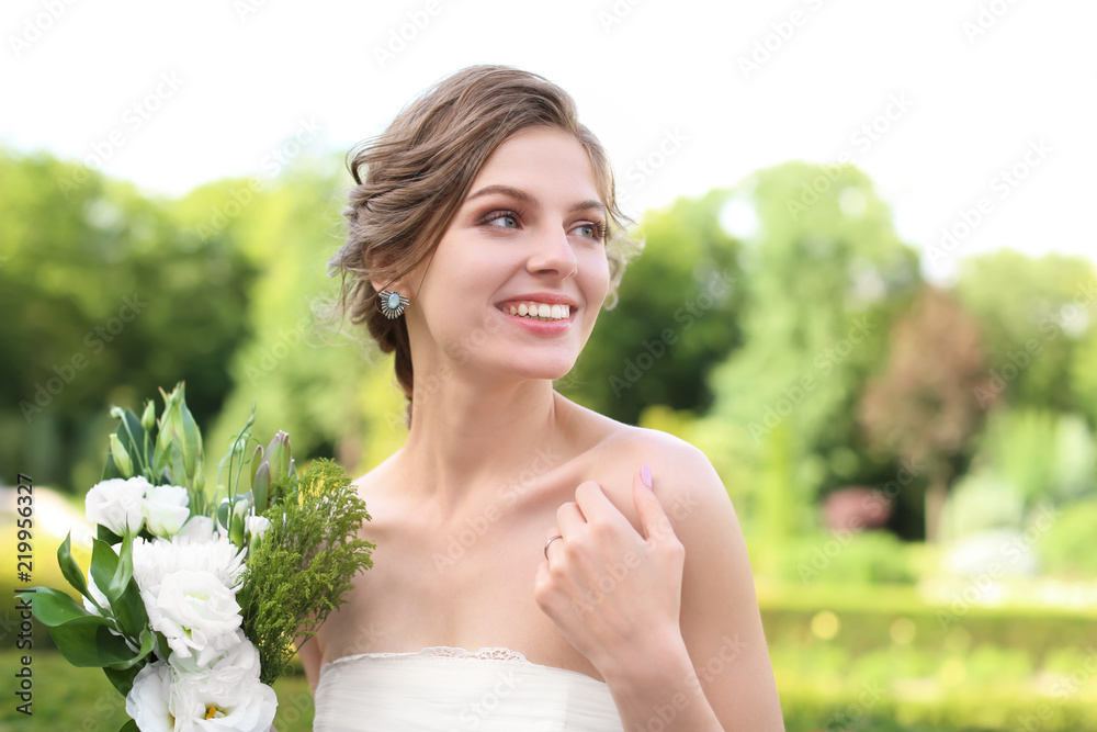 Beautiful young bride with wedding bouquet outdoors Beautiful young bride with wedding bouquet outdoors