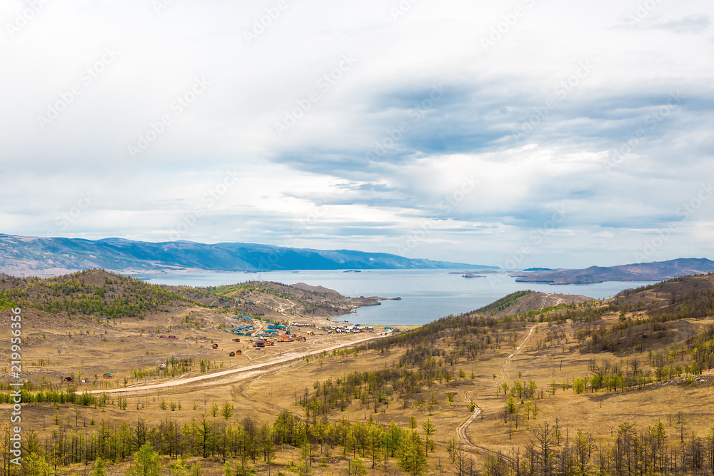 View of the Maloe More Strait, Curkut Bay and tourist centers on the shore. September. Lake Baikal, Siberia, Russia.