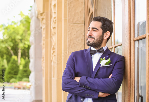 Handsome young groom in ele...