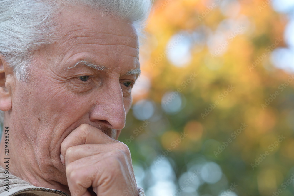 Close up portrait of sad senior man outdoors Close up portrait of sad senior man outdoors