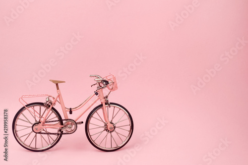Fototapeta Naklejka Na Ścianę i Meble -  Pink vintage bicycle on pink background. pastel minimal style concept.