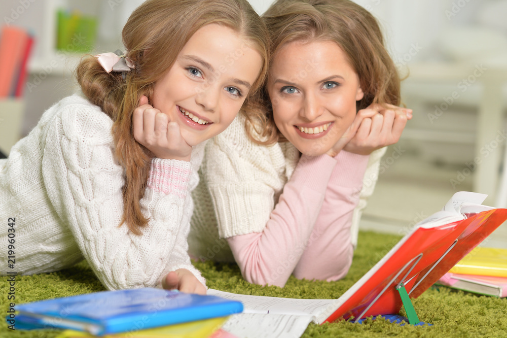 Portrait of a mother helps with homework Portrait of a mother helps with homework