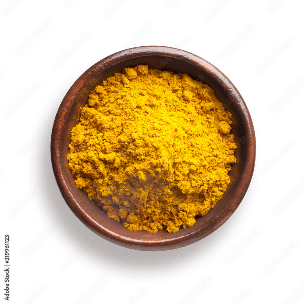 curry powder in a wooden bowl, isolated on white curry powder in a wooden bowl, isolated on white