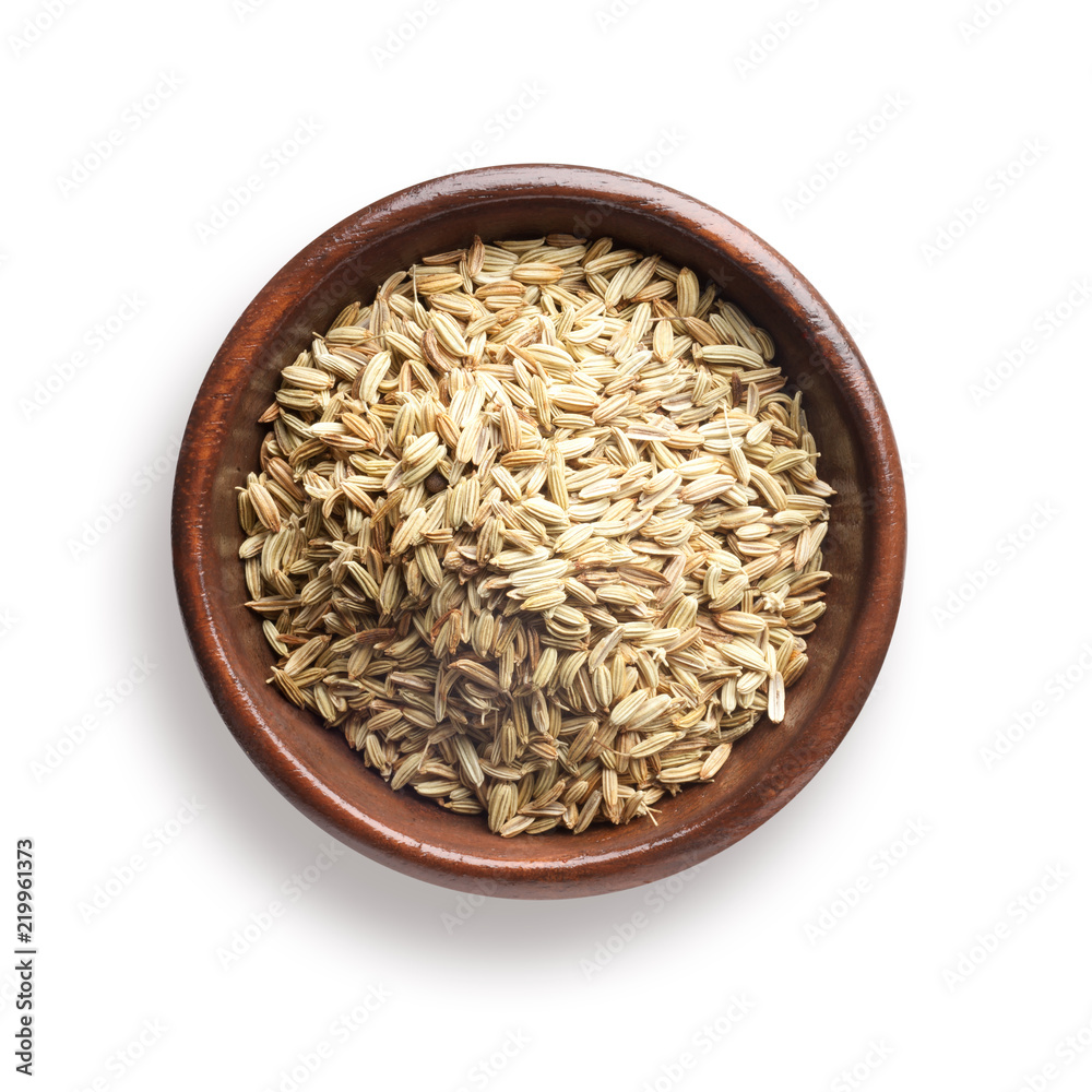 fennel seeds in a wooden bowl, isolated on white fennel seeds in a wooden bowl, isolated on white