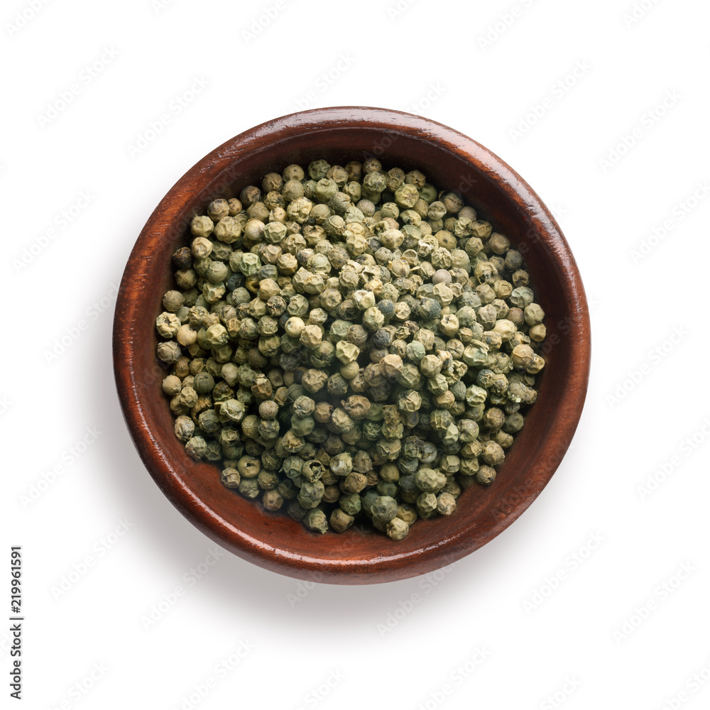 green pepper in a wooden bowl, isolated on white green pepper in a wooden bowl, isolated on white