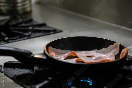 Bacon cooked in frying pan.