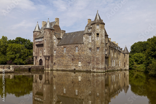 Chateau de Trecesson, mirrored in the clear waters of its moat photo