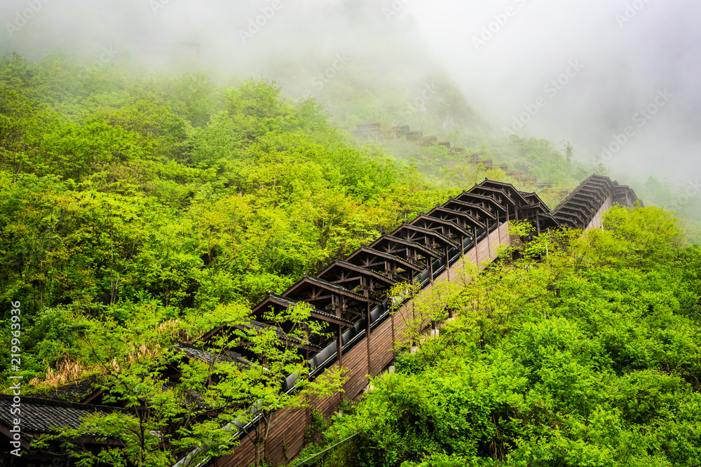 Escalator on mountain side at Enshi Mufu Grand Canyon scenic area and misty  mountains in China Photos | Adobe Stock