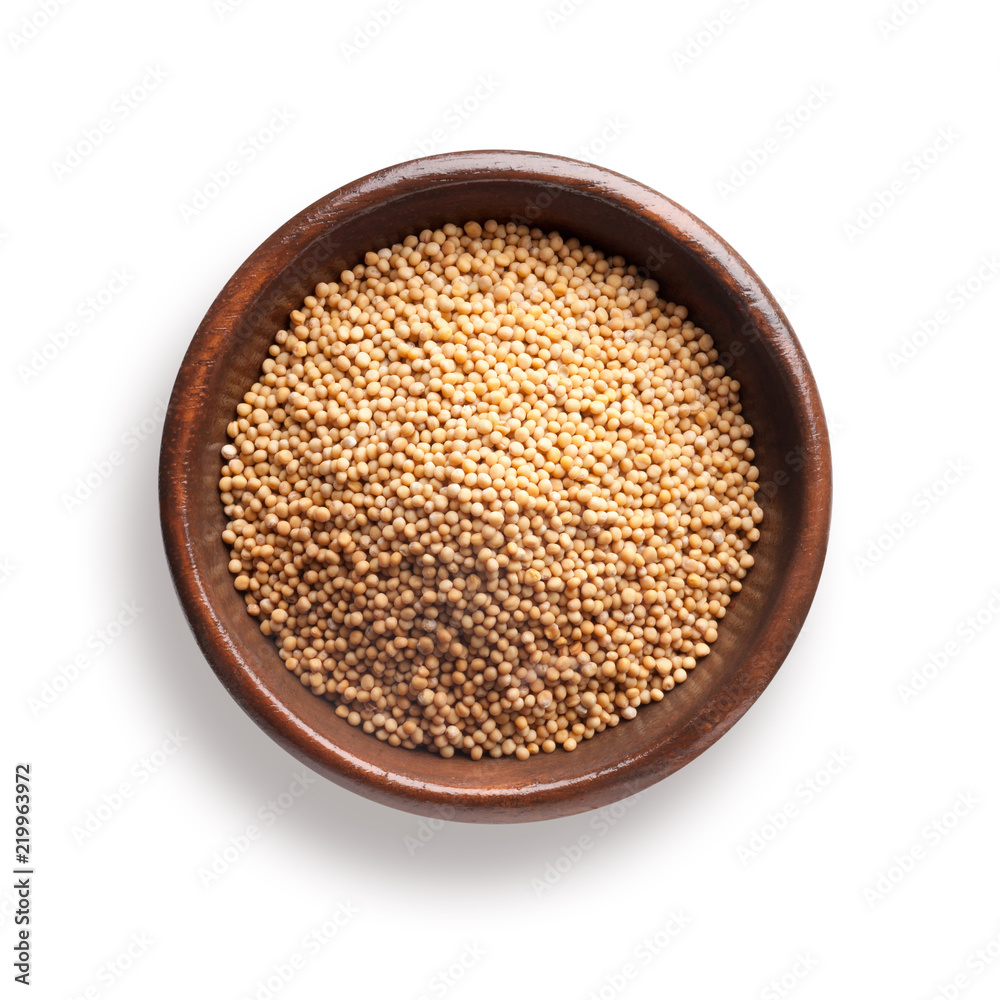 mustard seeds in a wooden bowl, isolated on white mustard seeds in a wooden bowl, isolated on white