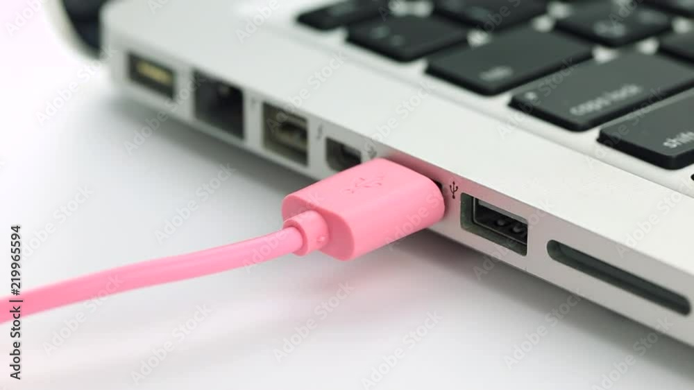 Plugging pink and black USB to laptop Plugging pink and black USB to laptop