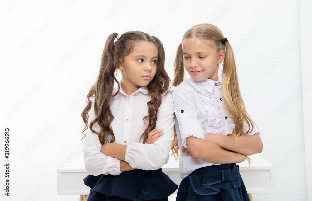 Little girls in school uniform keep arms crossed. Back to school and looking good in new school uniform. little girls. Little girls in school uniform keep arms crossed. Back to school and looking good in new school uniform. little girls.