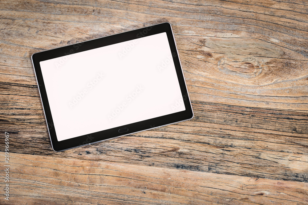Tablet with white empty screen on rustic wooden background. Tablet with white empty screen on rustic wooden background.