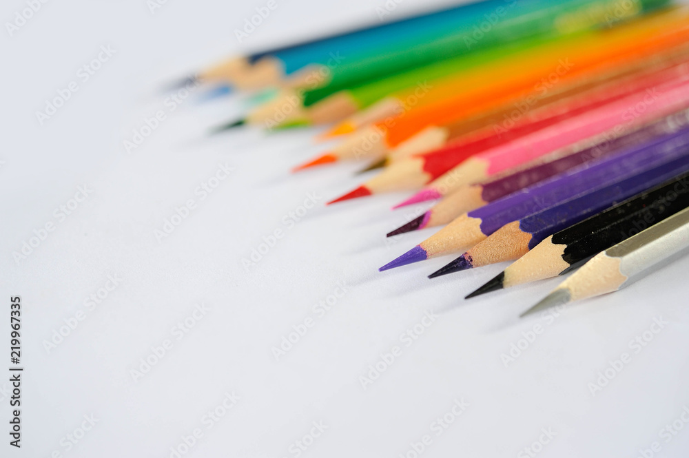 Colour pencil lay on white paper,Multi colour pencil put on white paper background,Scale colour of coulour pencil,Colour pencil rainbow style,Seletive focus