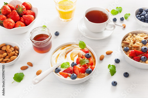 yogurt with strawberry blueberry honey almond and quinoa for breakfast