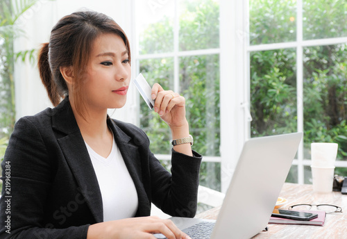 Asian woman shopping online and using her credit card for payment,Business women being a financial transaction with her credit card