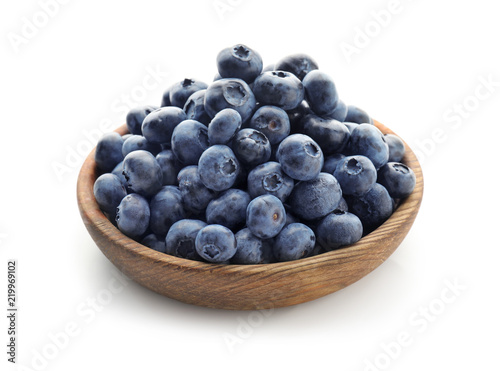 Bowl with ripe blueberries on white background