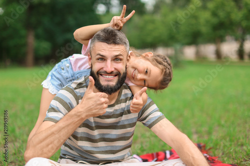 Funny portrait of little girl and her father outdoors © Pixel-Shot