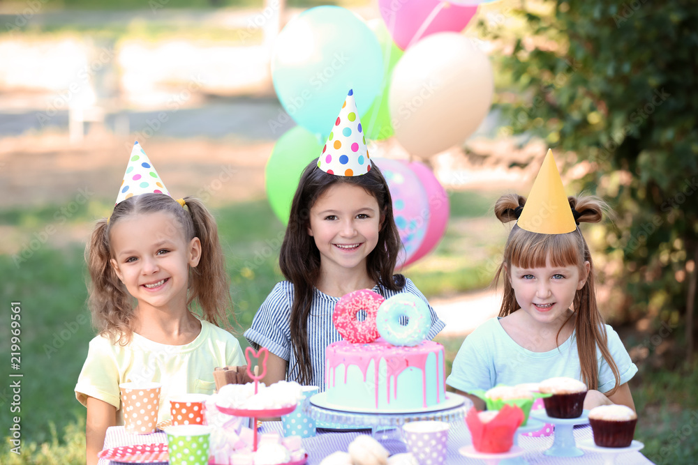 Cute little girls celebrating Birthday outdoors Cute little girls celebrating Birthday outdoors