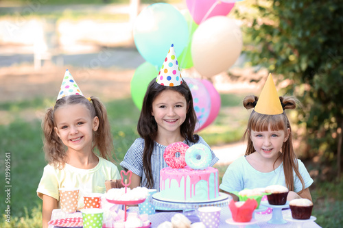 Cute little girls celebrating Birthday outdoors