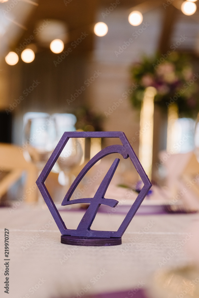 Figure in a figured frame on a wedding table.